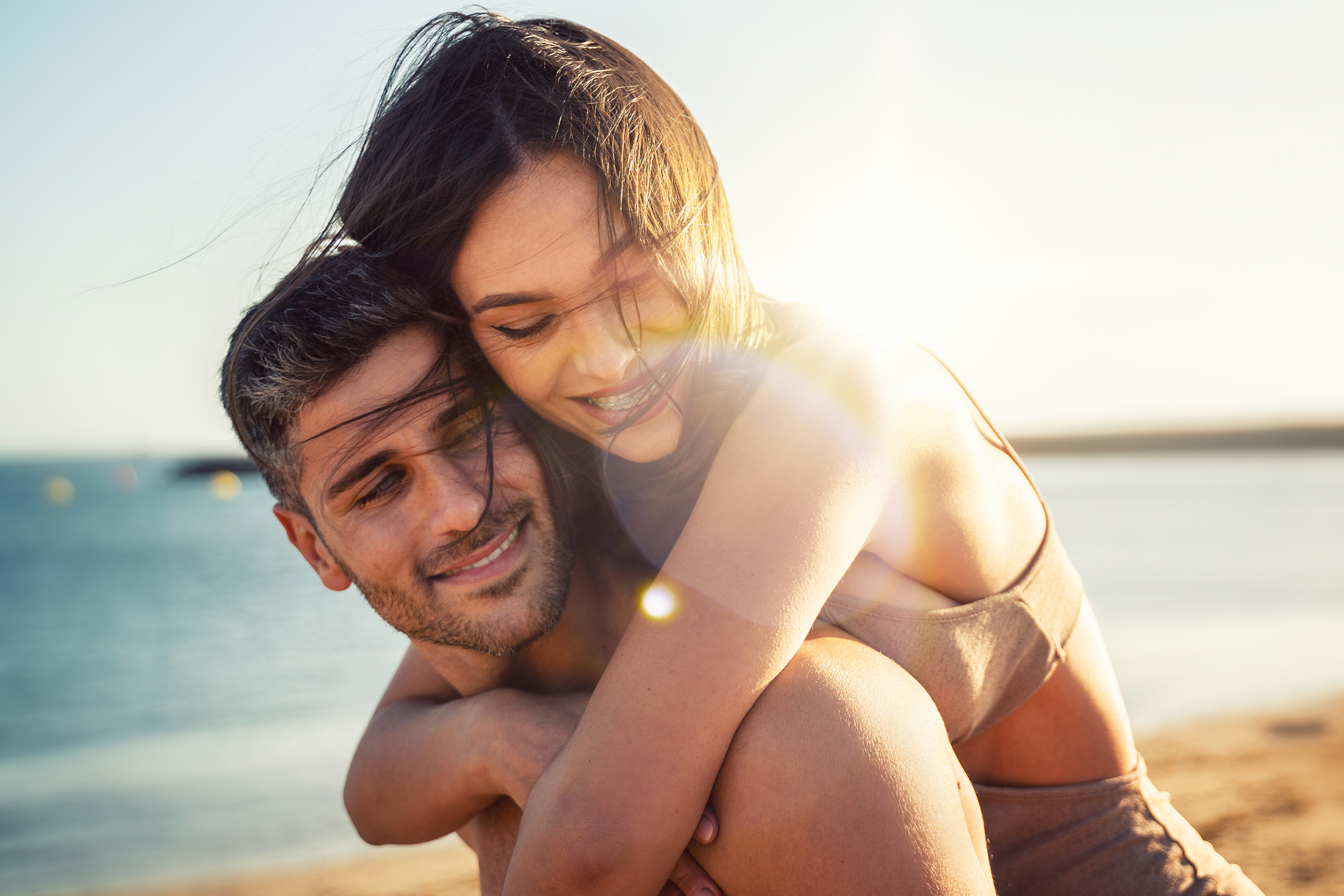 Smiling Man And Woman On Beach